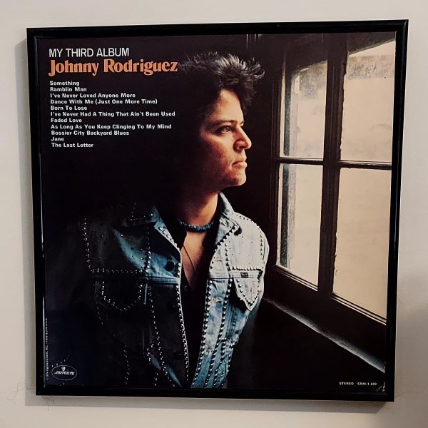 Johnny Rodriguez framed album cover art.